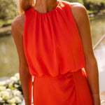 Red sleeveless midi dress with gathered high neckline and draped waist