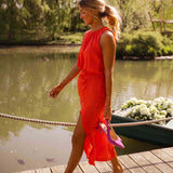 Red sleeveless midi dress with gathered waist, side slit, flowing fabric