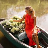 Red sleeveless midi dress with ruched bodice and long side slit