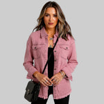 Dusty rose denim jacket with button front, chest pockets, and raw frayed hem