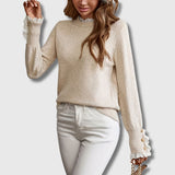 Beige crewneck lace pullover with decorative lace cuffs and button details