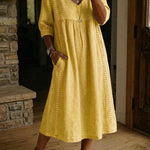 Antonia A-line maxi dress in mustard yellow, V-neck, 3/4 sleeves, pleated skirt.