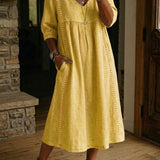 Antonia A-line maxi dress in mustard yellow, V-neck, 3/4 sleeves, pleated skirt.