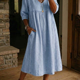 Antonia A-line maxi dress in light blue, V-neck, 3/4 sleeves, gathered skirt.