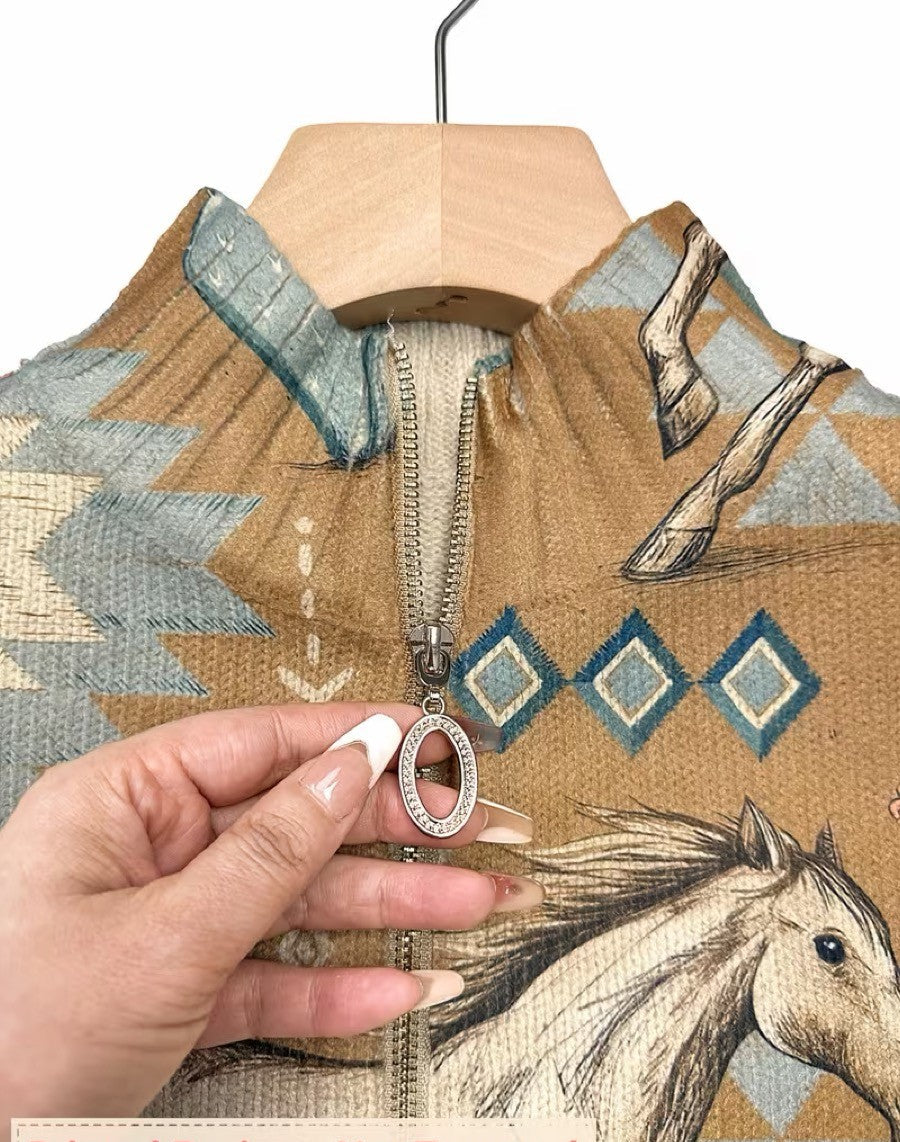 Women's knit jacket close-up: tan fabric, horse print, metal zipper pull.
