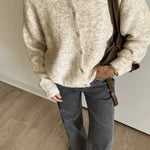 Beige long-sleeve button cardigan with crew neckline and ribbed hem