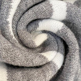 Gray knit cardigan fabric close-up with ribbed texture around hood