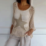 Cream crochet-style knit top with gold star patch, three-quarter sleeves, crew neckline