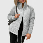 Light gray quilted jacket with zip front and ribbed knit sleeves