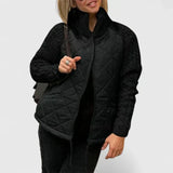 Black quilted jacket with zip front and ribbed knit sleeves