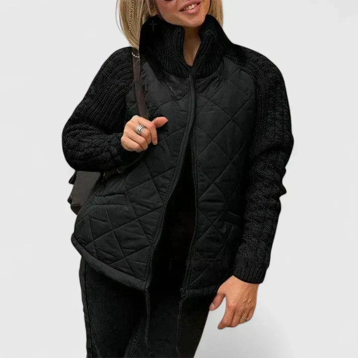 Black quilted jacket with zip front and ribbed knit sleeves