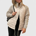 Beige quilted jacket with zip front and ribbed knit sleeves