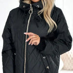 Black quilted hooded jacket showing front zipper and ring pull with drawstring hood cords