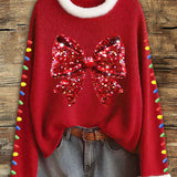 Women's red Christmas top with sequin bow and white faux-fur trim