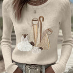 Women’s knit top with nativity scene applique, long sleeves, crew neck, off-white