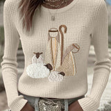 Women’s knit top with nativity scene applique, long sleeves, crew neck, off-white