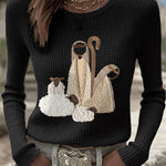 Women’s knit top with nativity scene applique, long sleeves, crew neck, black