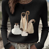 Women’s knit top with nativity scene applique, long sleeves, crew neck, black