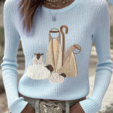 Women’s knit top with nativity scene applique, long sleeves, crew neck, light blue