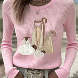 Women’s knit top with nativity scene applique, long sleeves, crew neck, light pink