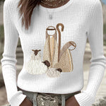 Women’s knit top with nativity scene applique, long sleeves, crew neck, off-white
