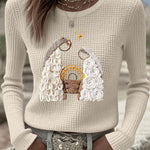 Beige waffle-knit long-sleeve sweater with nativity scene graphic