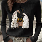 Women's black waffle-knit long-sleeve top with embroidered nativity scene