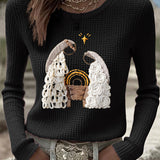 Women's black waffle-knit long-sleeve top with embroidered nativity scene