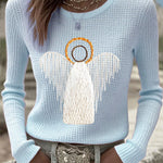 Light blue knit sweater with angel nativity graphic, long sleeves