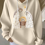 Cream ribbed women’s hoodie with embroidered nativity scene and drawstring hood