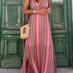 Red halterneck maxi dress with zigzag tribal pattern and draped, flared skirt