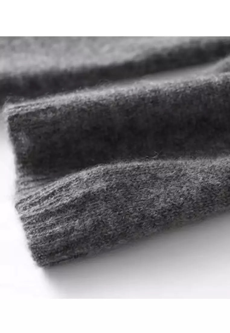 Heathered dark gray knit sweater fabric swatch with long-sleeve cuff