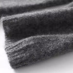 Heathered dark gray knit sweater fabric swatch with long-sleeve cuff