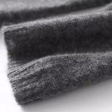 Heathered dark gray knit sweater fabric swatch with long-sleeve cuff