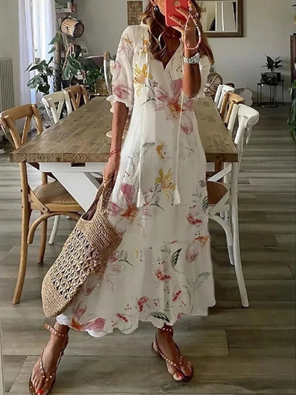 Boho midi dress in white with pastel floral print, short sleeves and tiered hem
