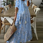 Boho midi dress in light blue with small floral print, short sleeves and tiered hem