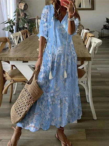 Boho midi dress in light blue with small floral print, short sleeves and tiered hem