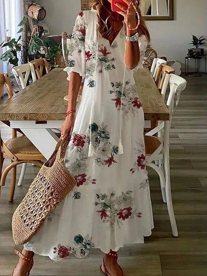 Boho midi dress in white with red and green floral print, short sleeves and tiered hem