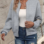 Grey bomber jacket with zip front and textured chevron knit, ribbed cuffs and hem.