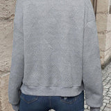 Grey long-sleeve bomber jacket, back view, textured chevron knit and ribbed hem.