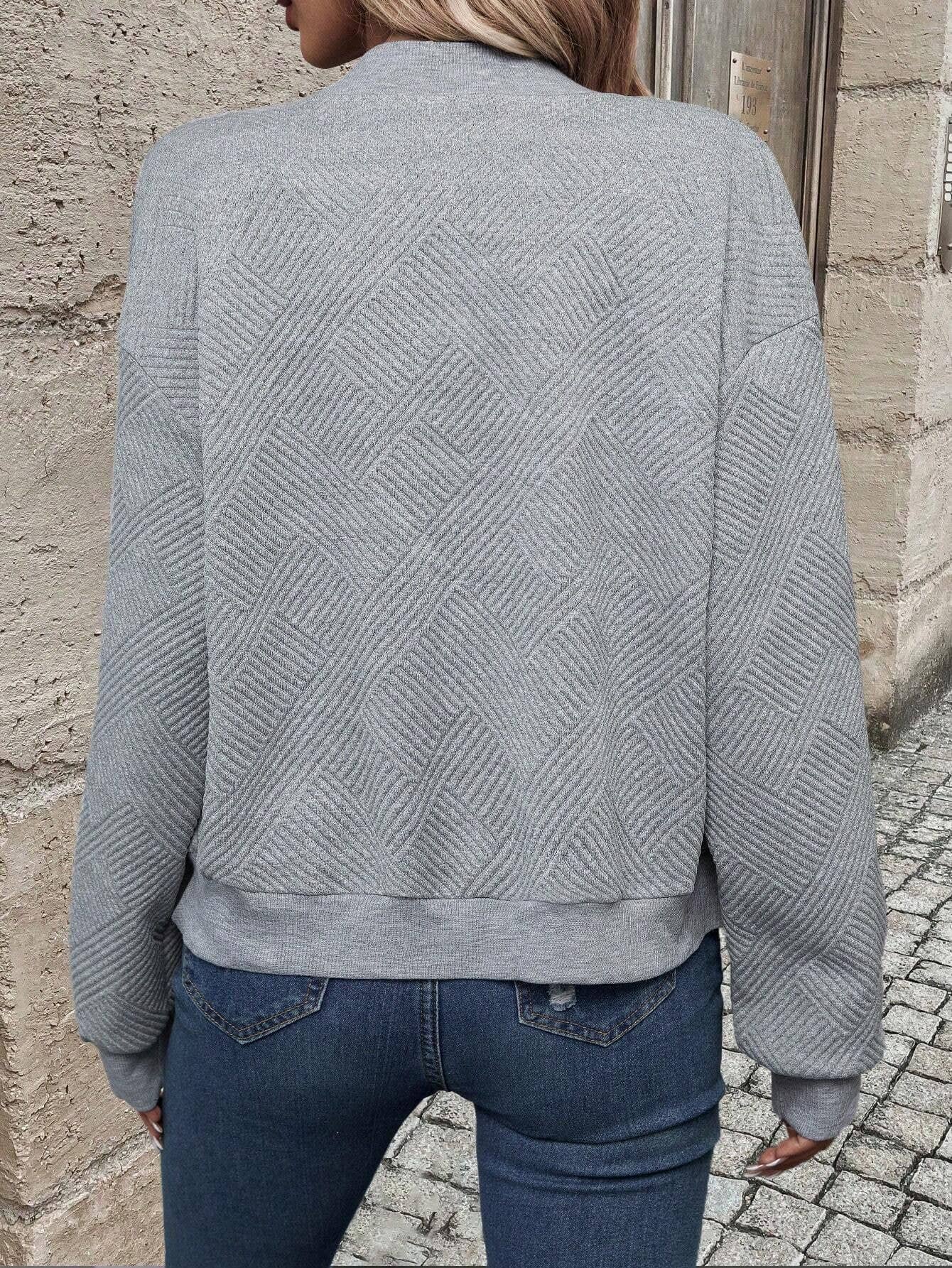 Grey long-sleeve bomber jacket, back view, textured chevron knit and ribbed hem.