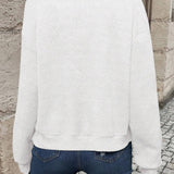 White bomber jacket, back view, textured chevron knit and ribbed hem.