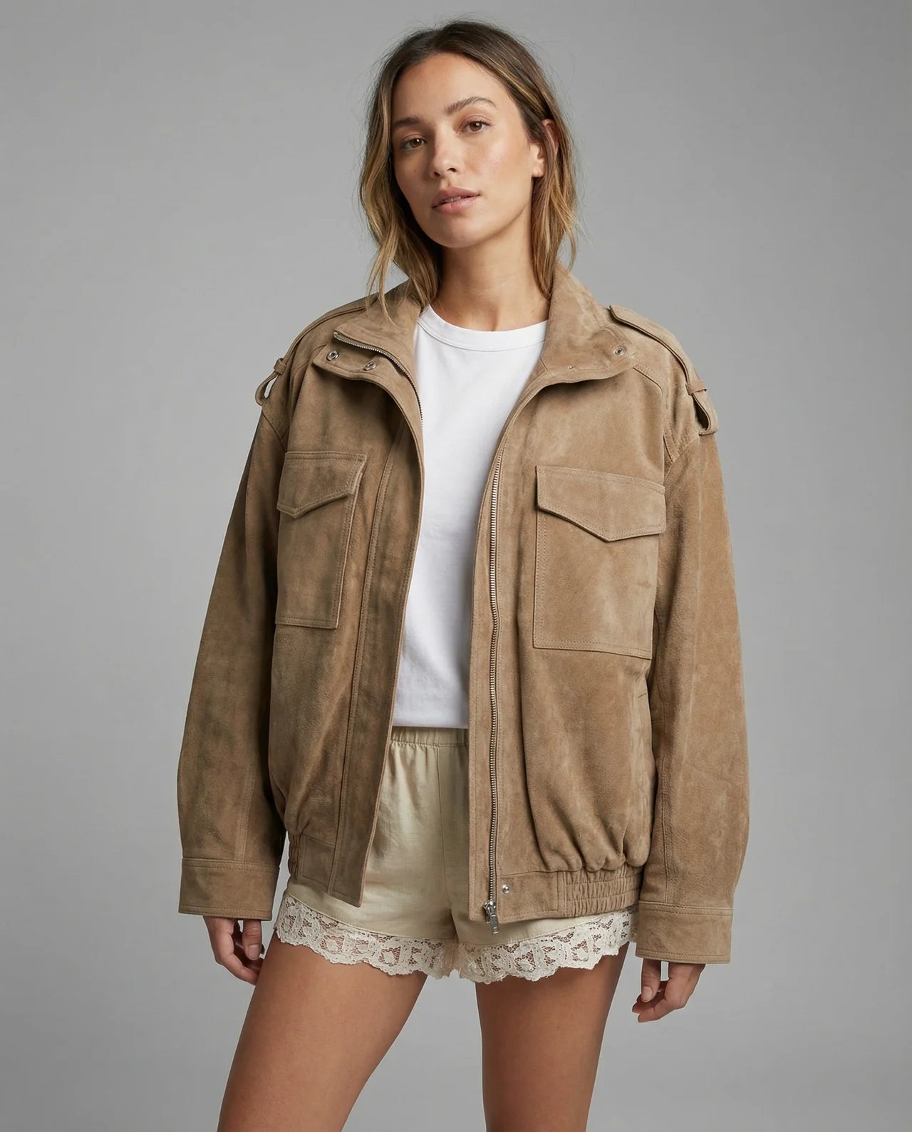 Womens light-brown bomber jacket with zipper, flap pockets, and stand collar