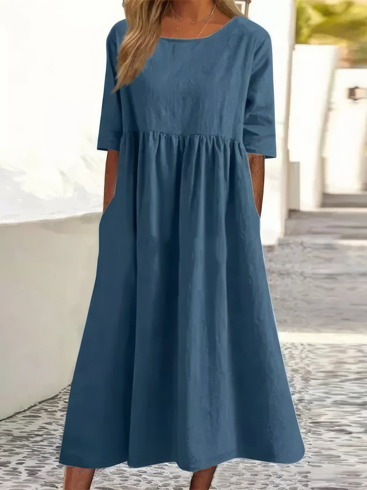 Blue cotton round-neck dress with short sleeves and gathered waist