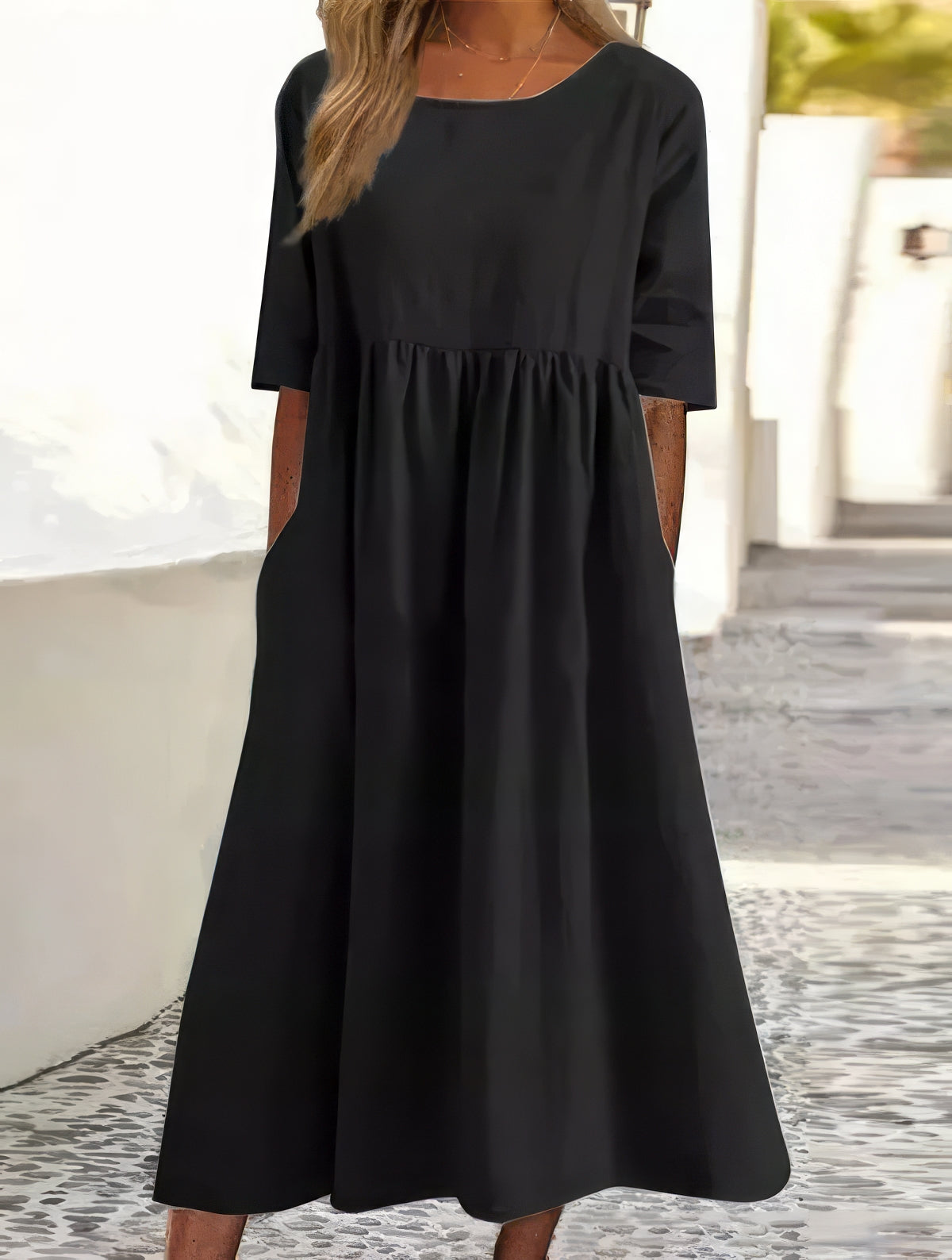 Black cotton round-neck dress with short sleeves and gathered waist