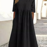 Black cotton round-neck dress with short sleeves and gathered waist