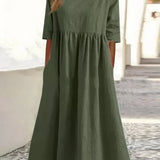 Green cotton round-neck dress with short sleeves and gathered waist