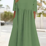 Light green cotton round-neck dress with short sleeves and gathered waist