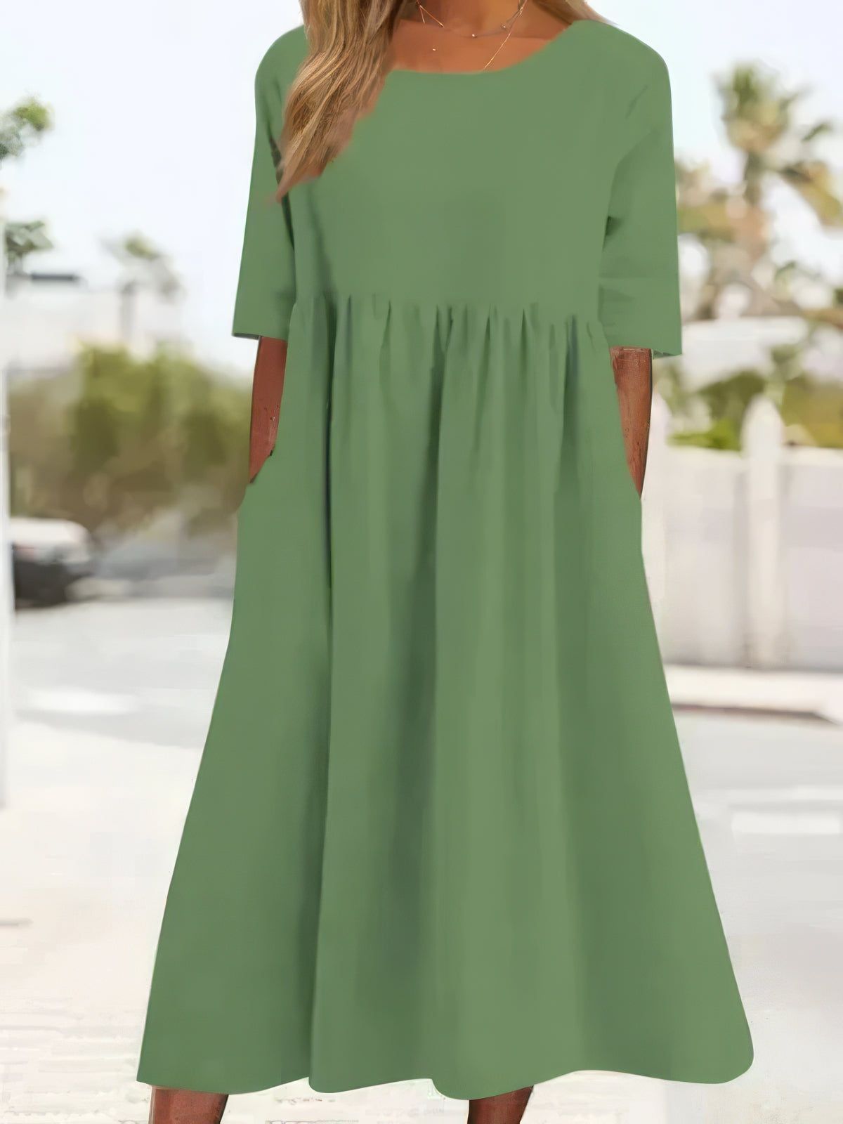 Light green cotton round-neck dress with short sleeves and gathered waist